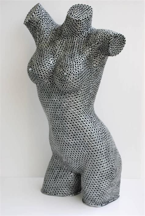 classical woman metal sculpture with fabric at waist|Torso of a woman .